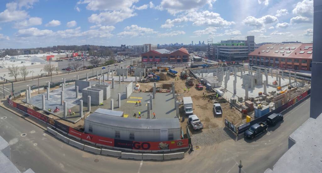 Aerial view of the active construction site at Arsenal Yards, showcasing the transformation of the former mall into a modern, mixed-use development in Watertown, Massachusetts
