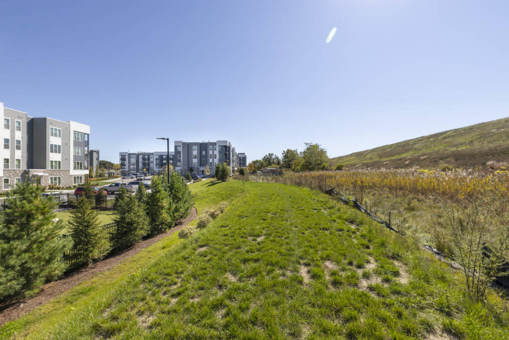 grassy hill on the right at 318 Station Woburn with building and fencing