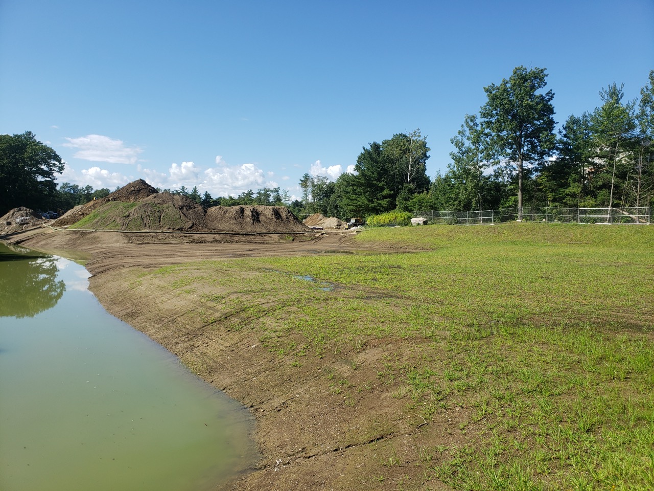 50 Nagog Park Acton MA prior to development grassy land with water and trees