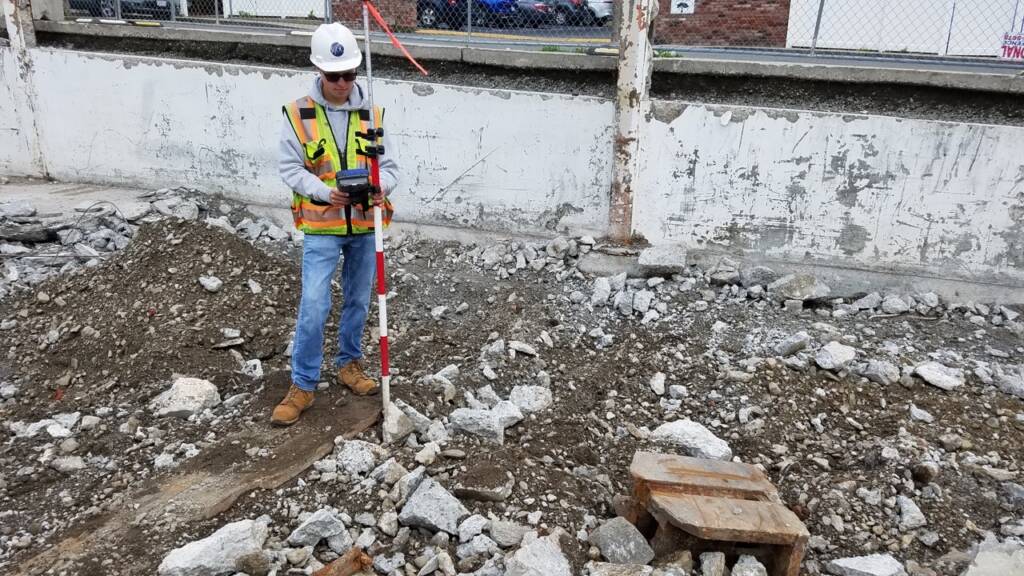 Surveyor performing construction layout work during redevelopment of Chelsea Point in Franklin, MA