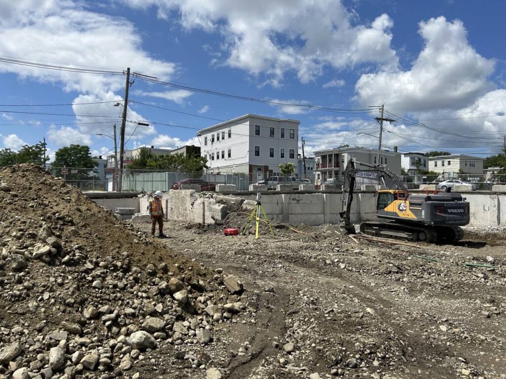 Construction survey equipment and field layout work at the Chelsea Point redevelopment site in Franklin, MA
