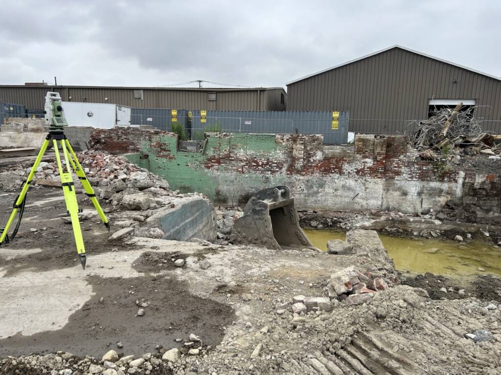 Survey equipment positioned during demolition and site preparation at Chelsea Point in Franklin, MA