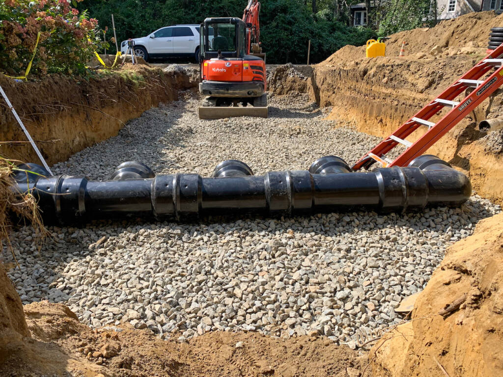 Underground drainage system installation with large stormwater pipe and stone base at 24M Westwood construction site