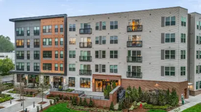 Hanover Stoneham apartment community exterior with modern façade, balconies, and landscaped entry in Stoneham, Massachusetts