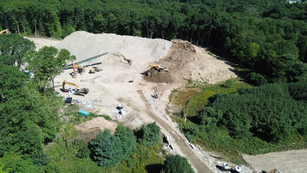 Drone view of grading, earthwork, and construction equipment at Franklin Grove Apartments in Franklin, Massachusetts.