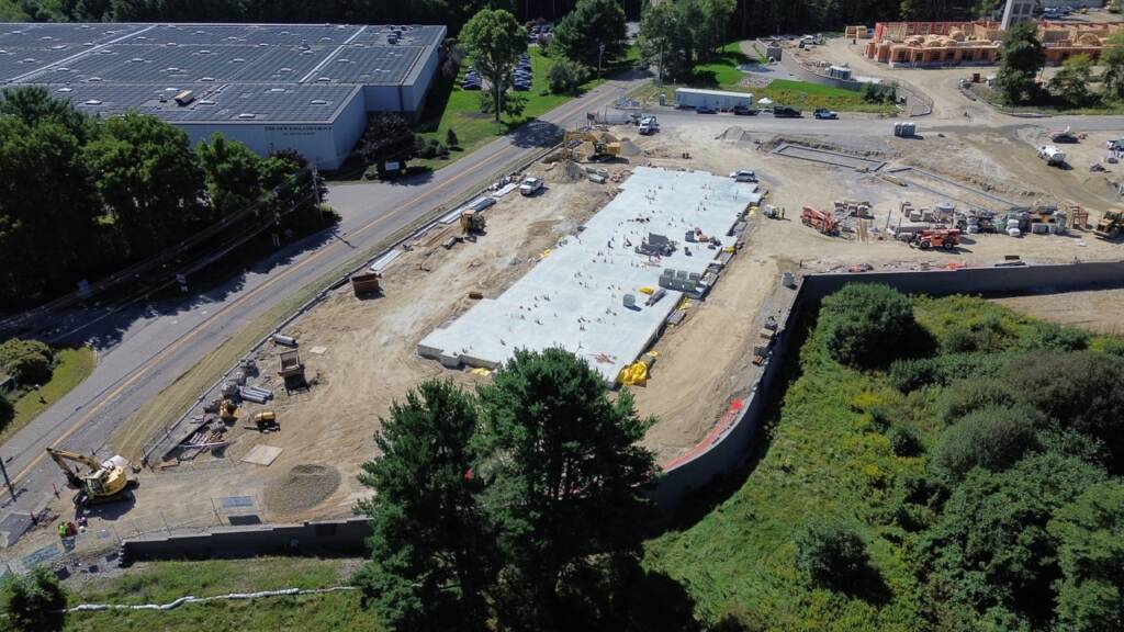 Aerial view of the multi-building Franklin Grove Apartments development under construction in Franklin, MA.