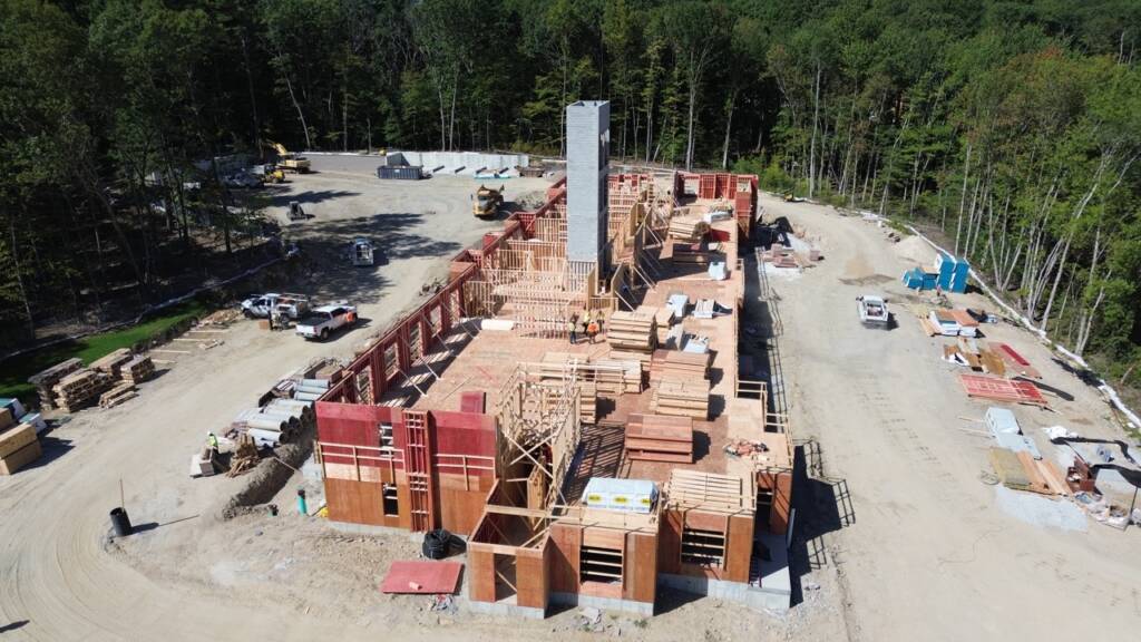 Drone view of wood framing and site construction progress at Franklin Grove Apartments in Franklin, Massachusetts.